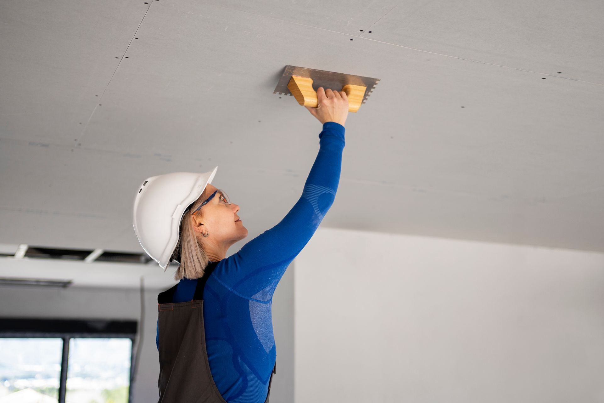 woman fixing ceiling
