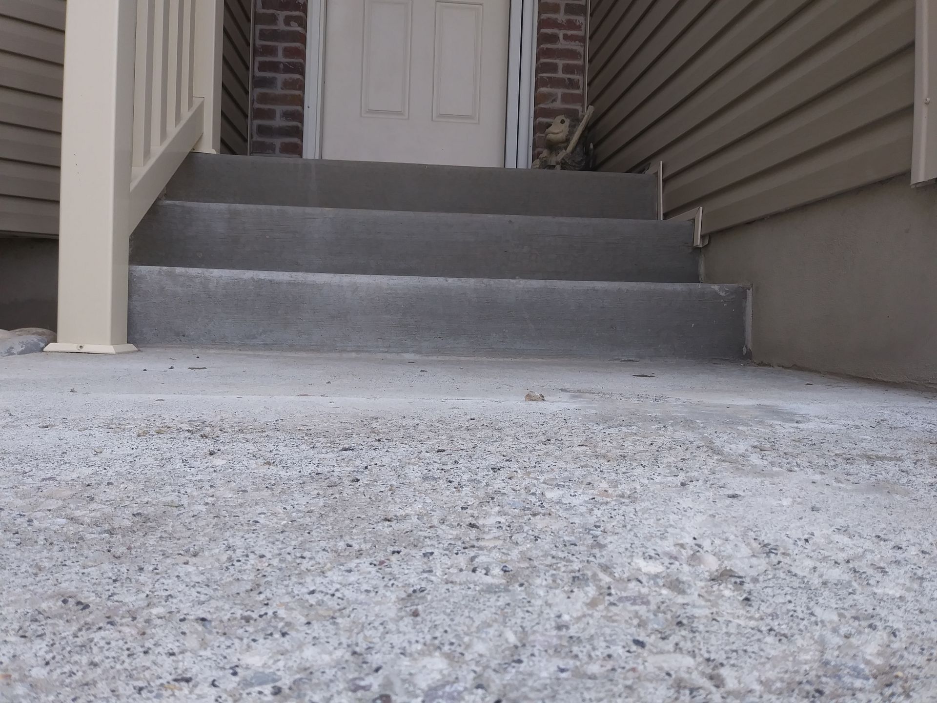A set of stairs leading up to the front door of a house