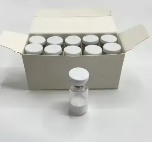 Box of vials, one in front. Vials are clear glass with white tops. White powder visible inside.