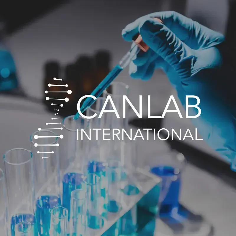 A person in blue gloves holding a pipette over test tubes with blue liquid; CANLAB International logo is present.
