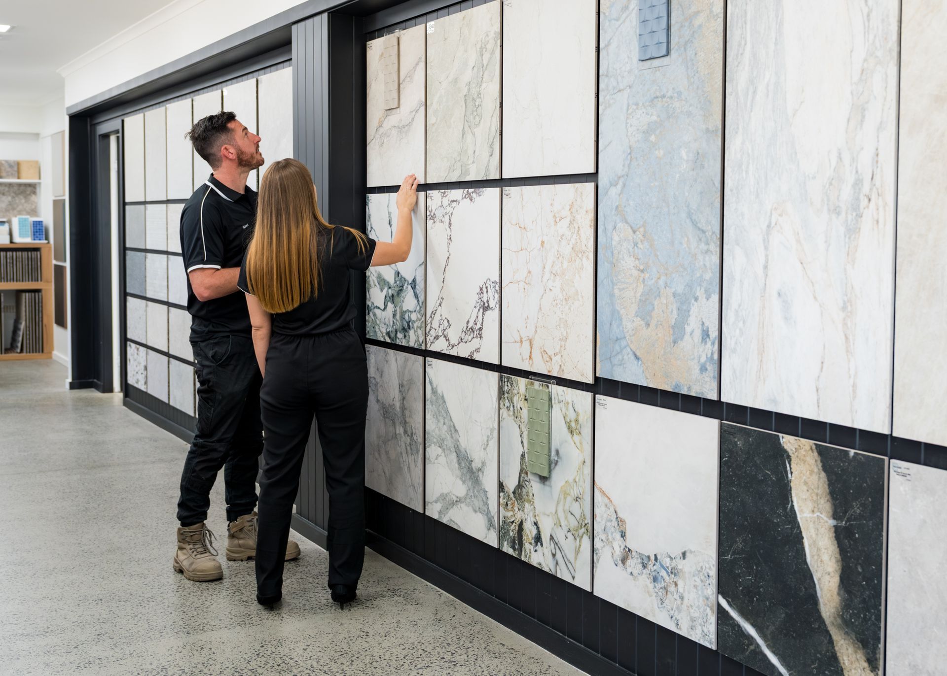 A Man And Woman Looking At Tiles — Coastwide Tile Studio in West Gosford, NSW