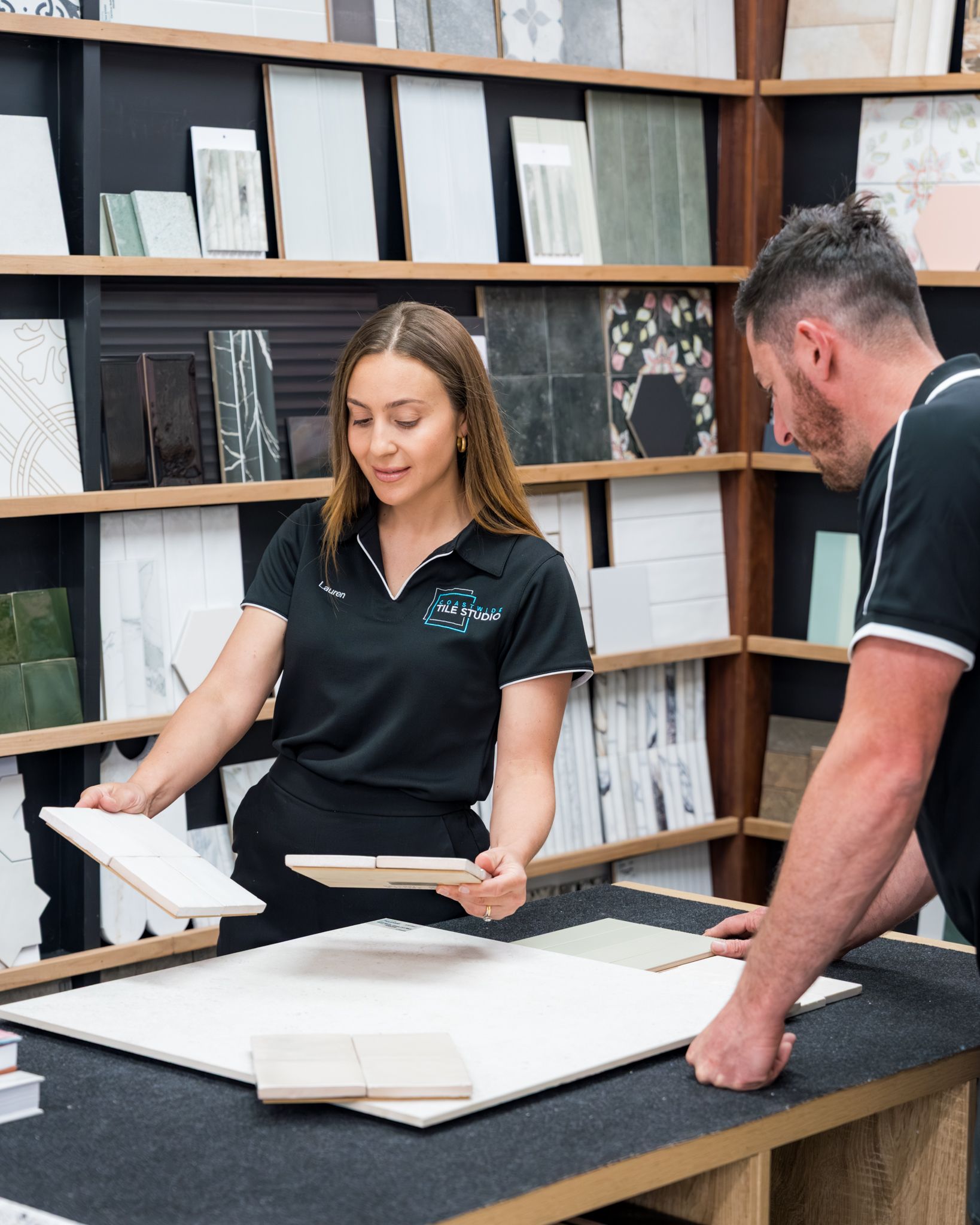A Woman Holding White and Beige Tiles — Coastwide Tile Studio in West Gosford, NSW