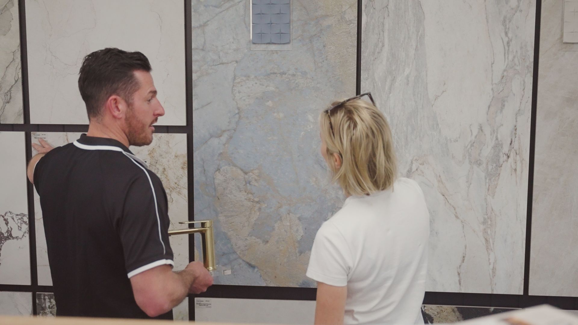 A Woman Holding Up Tiles — Coastwide Tile Studio in West Gosford, NSW