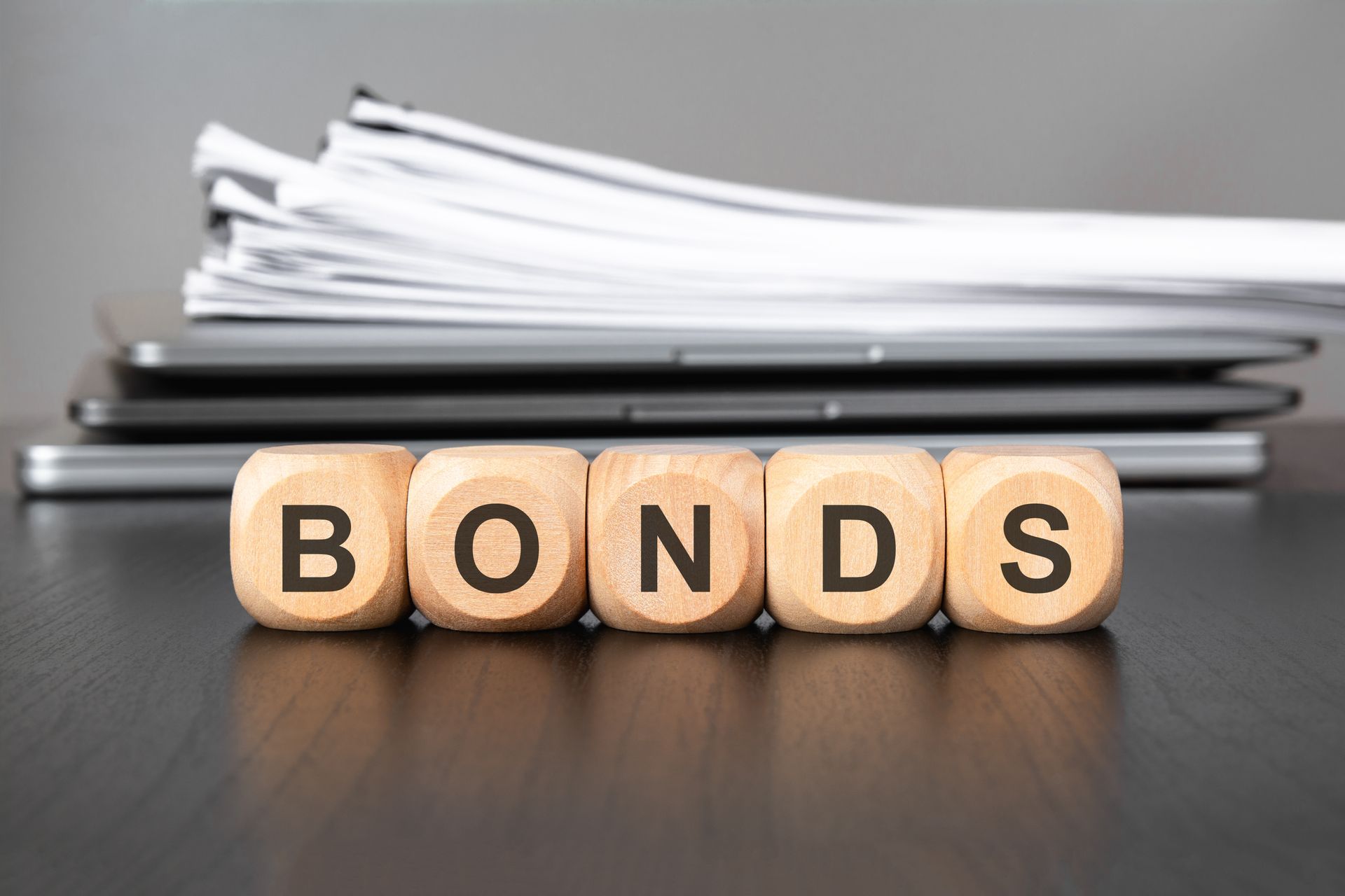 Hand on tablet showing colorful candlestick stock chart with green and red bars