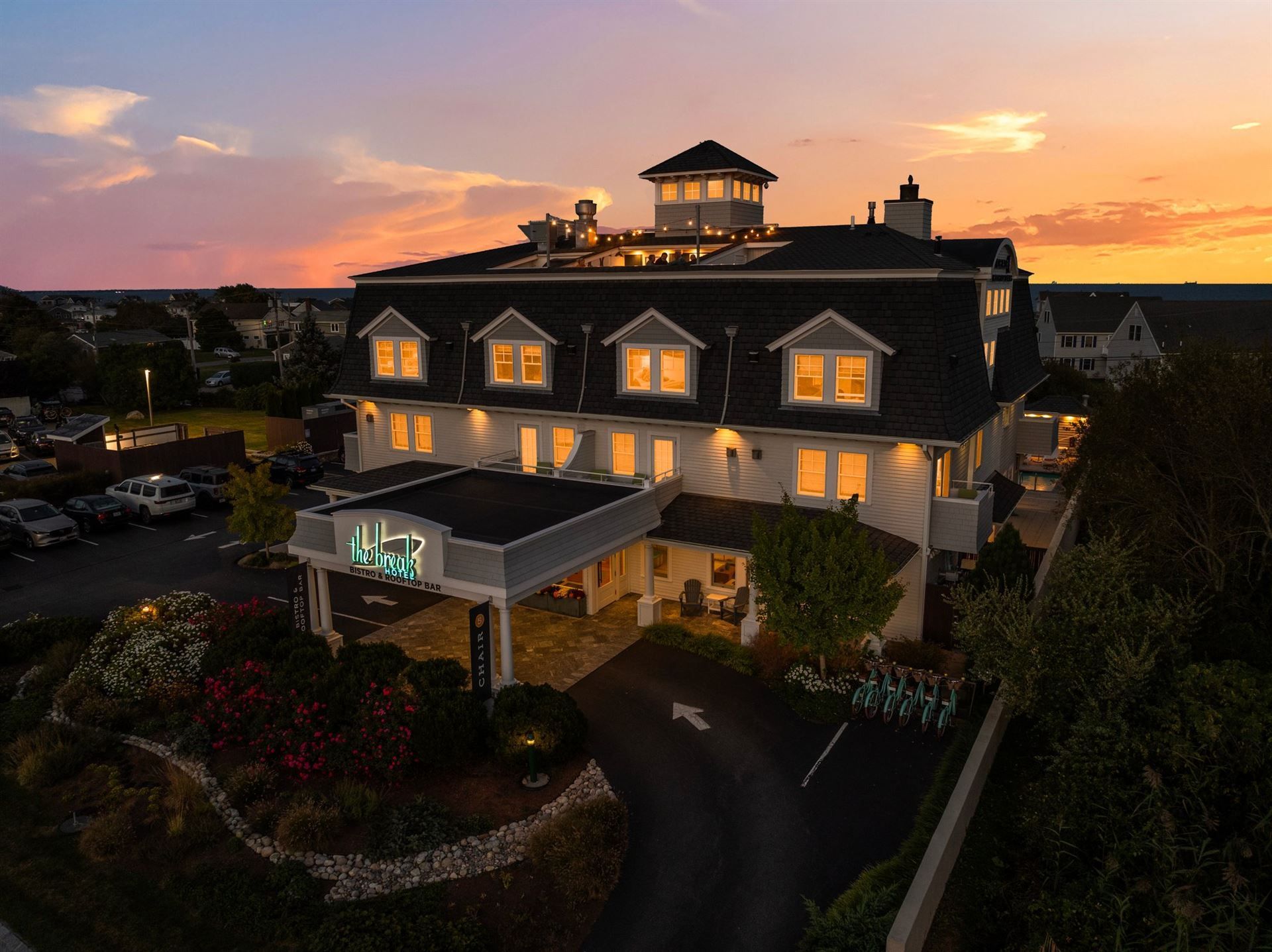 An aerial view of a large hotel at sunset