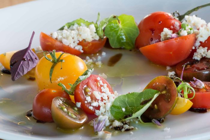 There are many different types of tomatoes on the plate.