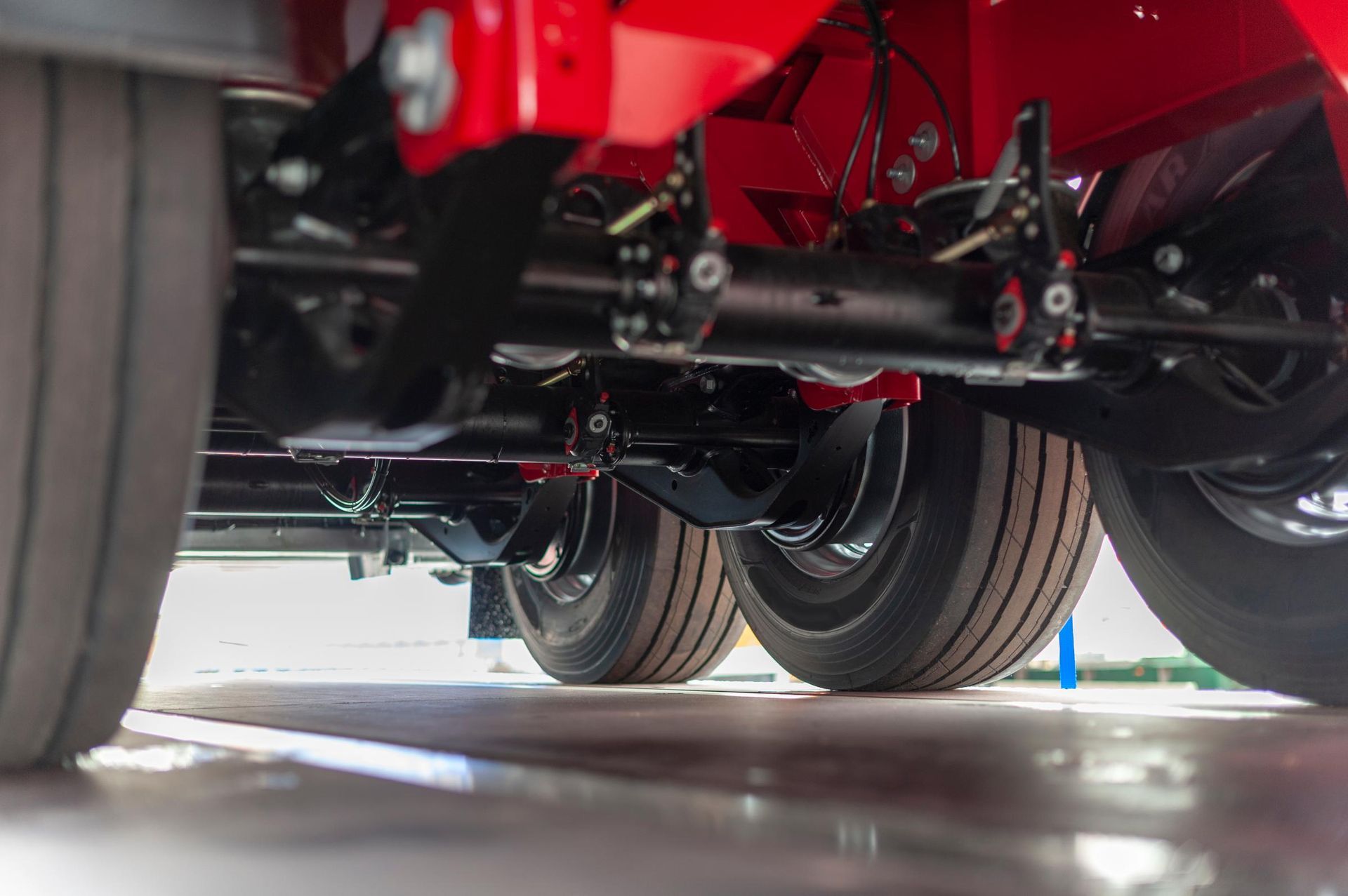 A close up of the underside of a red truck.