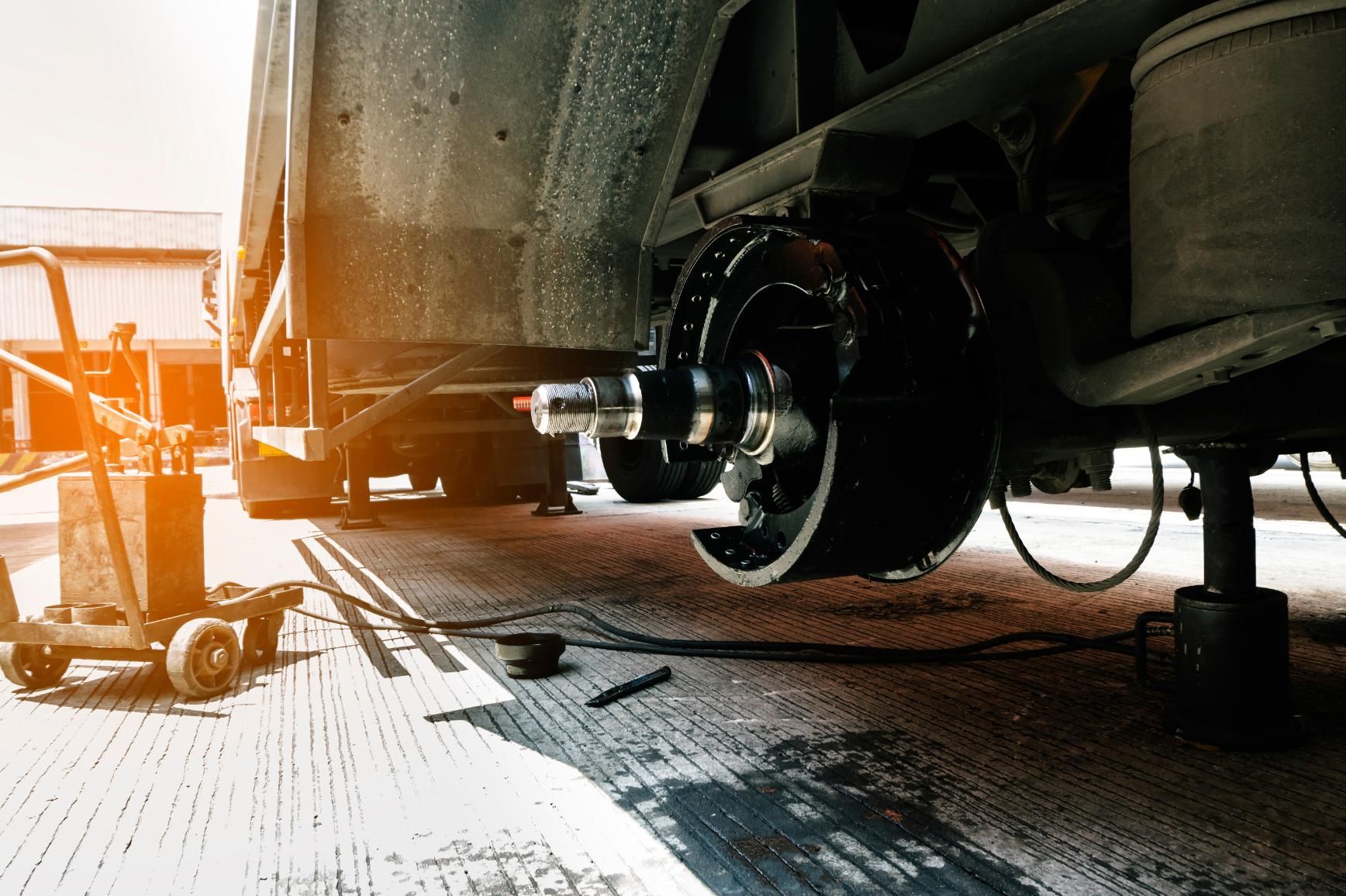 A truck is being repaired on the side of the road.