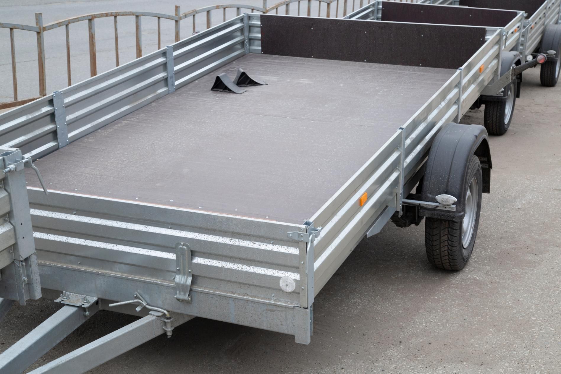 A row of trailers are parked on the side of the road.