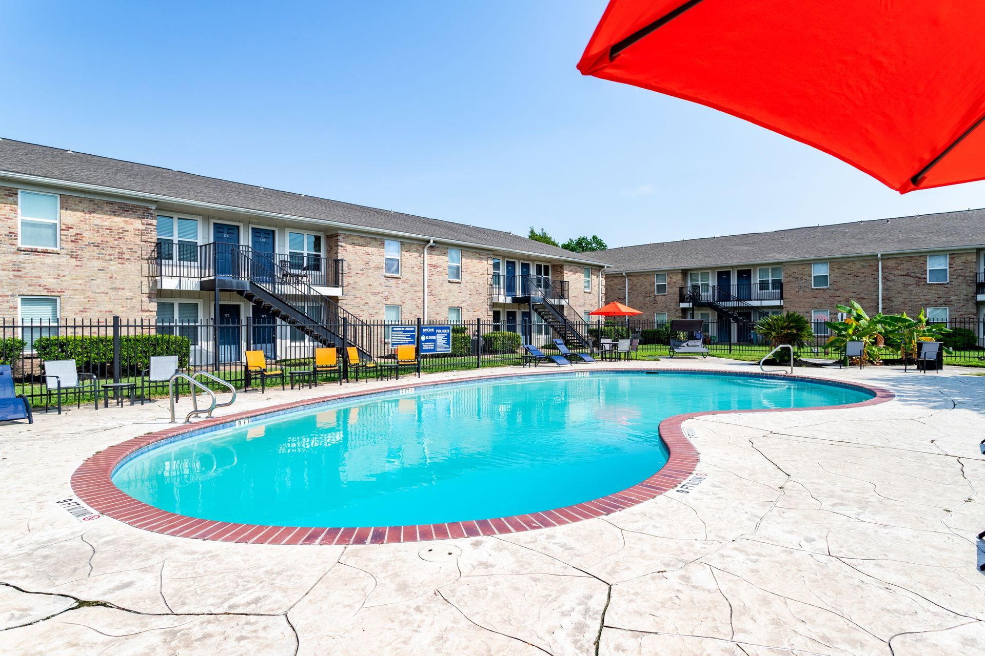 A swimming pool area at Baystone Apartments in Webster, TX.