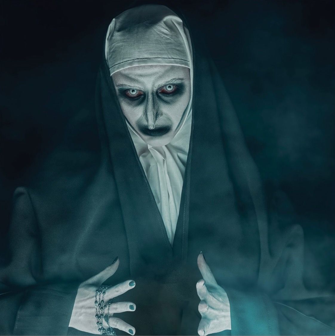 A demonic nun with pale skin, glowing eyes, and dark makeup, surrounded by mist.