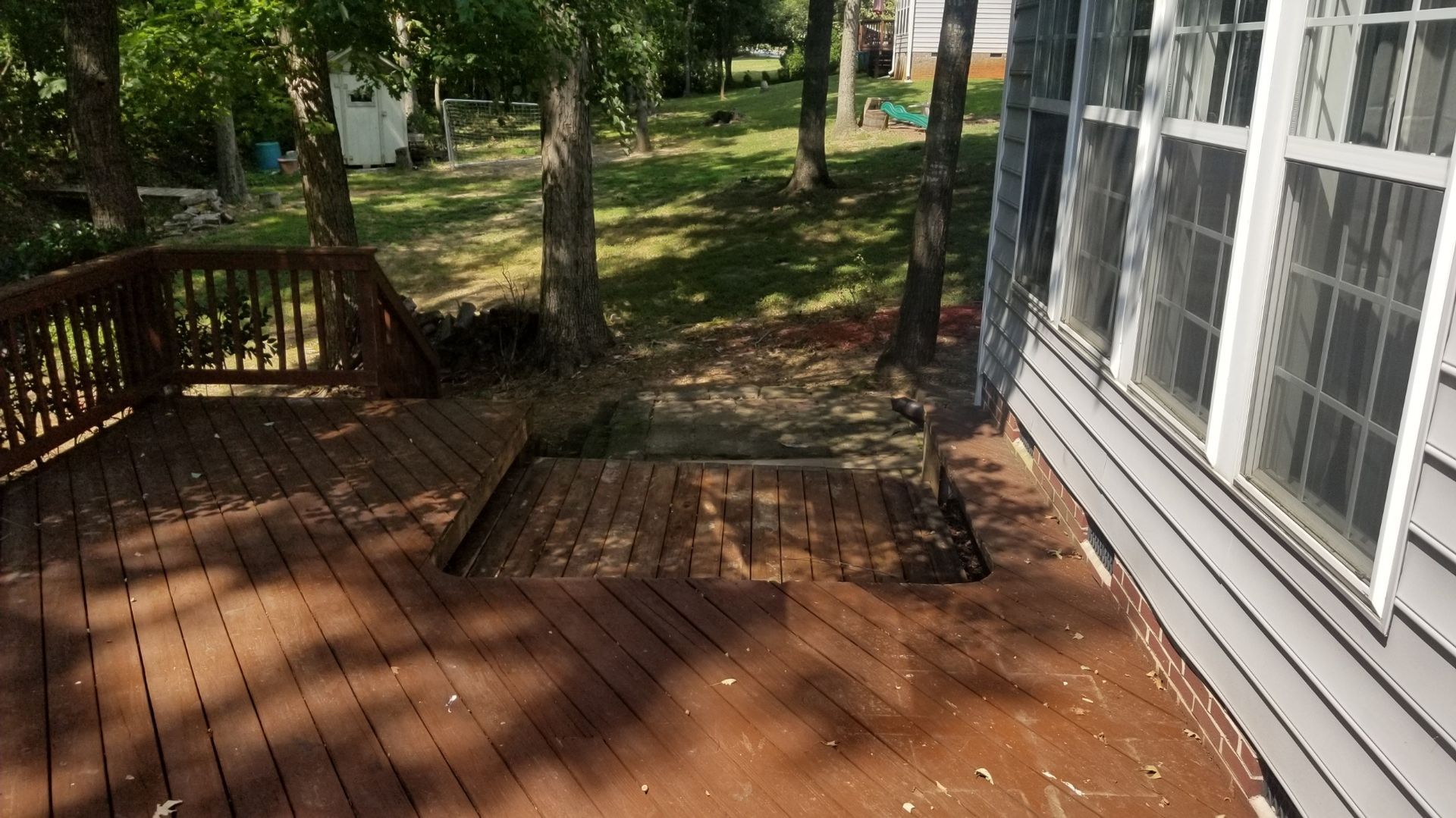 A house with a screened in porch and a wooden deck