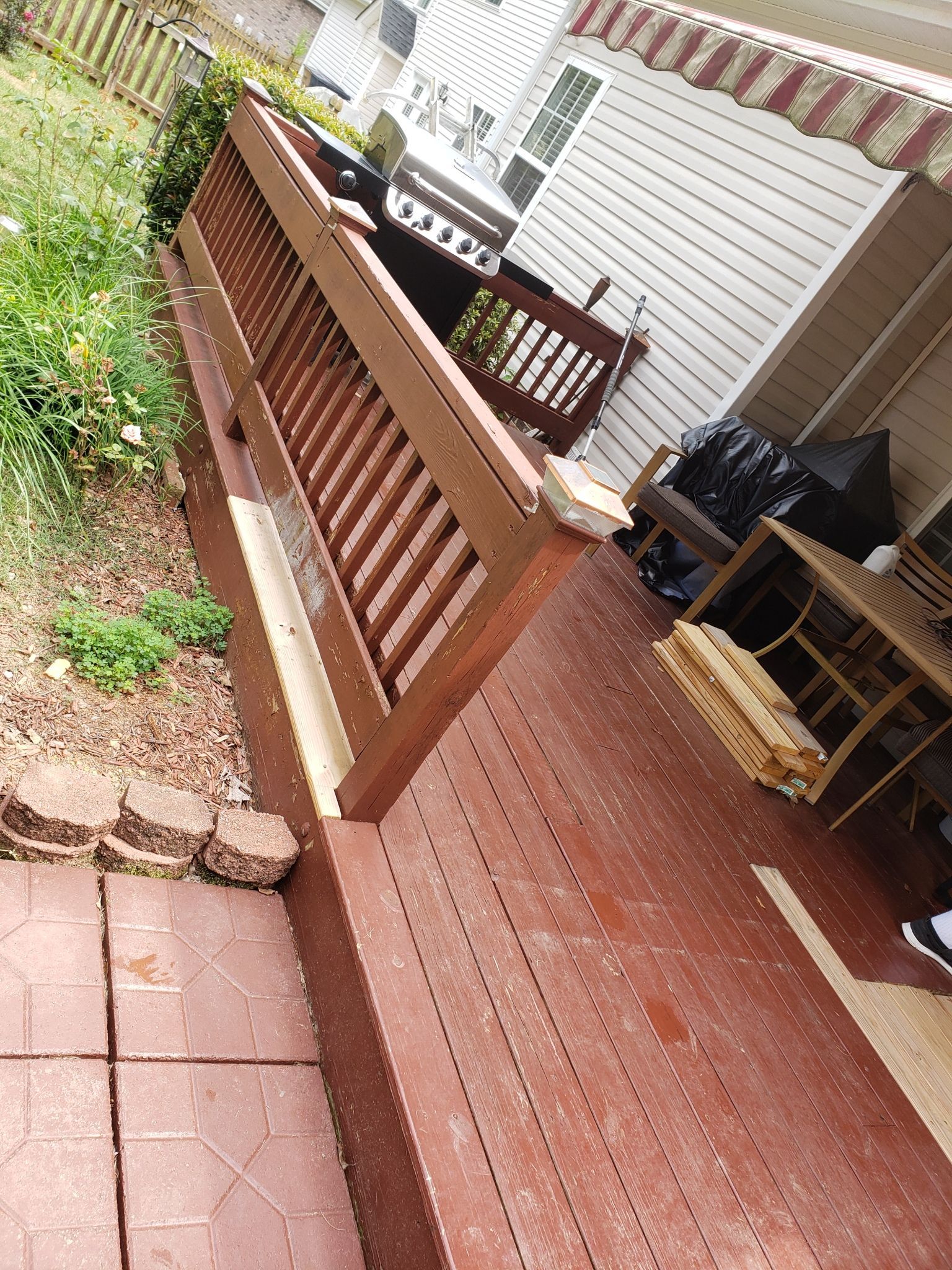 A wooden deck with a bench and a table on it.