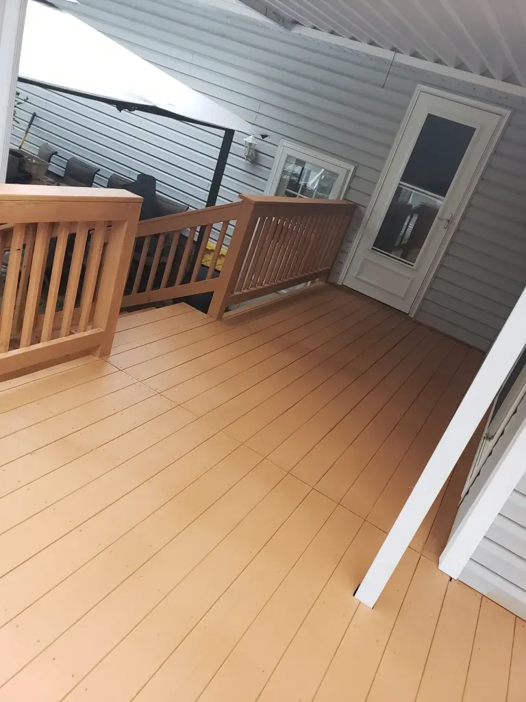 A wooden deck with a staircase leading up to it