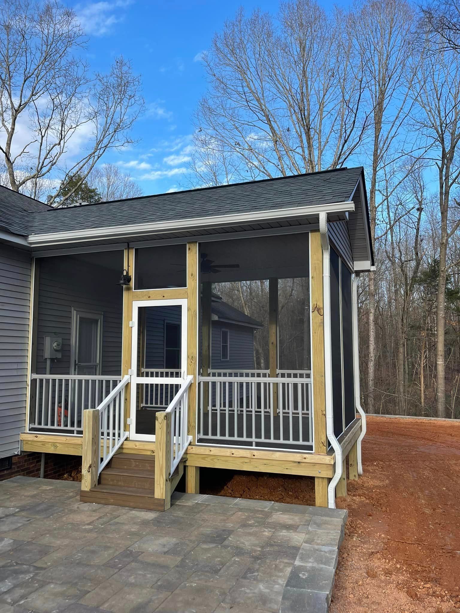 A screened in porch with stairs leading up to it