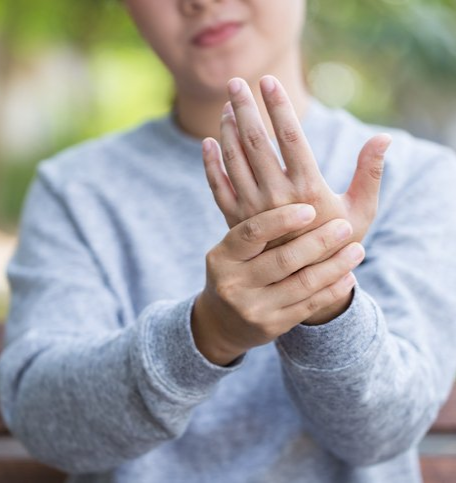 Woman has hand pain at park