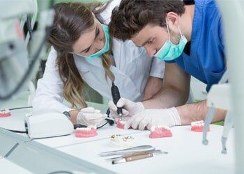 Male and Female Prosthodontist Working on Dentures — Prosthodontics in Beaumont, TX