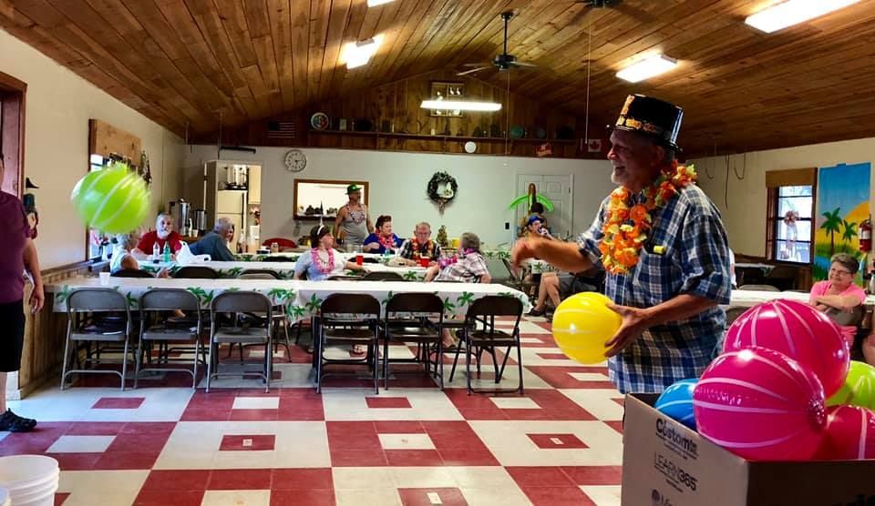 a man in a top hat stands in front of a box that says lg on it