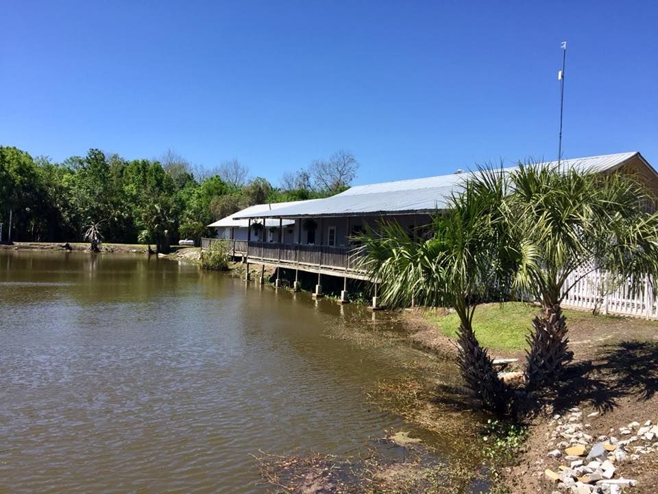 a house sits on a dock overlooking a body of water