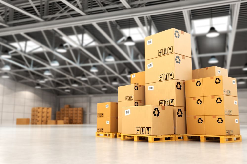 A Warehouse Filled With Lots of Cardboard Boxes on Wooden Pallets — Wide Bay Removals In Dundowran, QLD A Warehouse Filled With Lots of Cardboard Boxes on Wooden Pallets — Wide Bay Removals In Dundowran, QLD