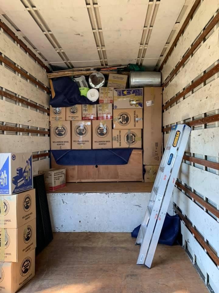 The Inside of a Moving Truck Filled With Boxes and a Ladder — Wide Bay Removals In Dundowran, QLD