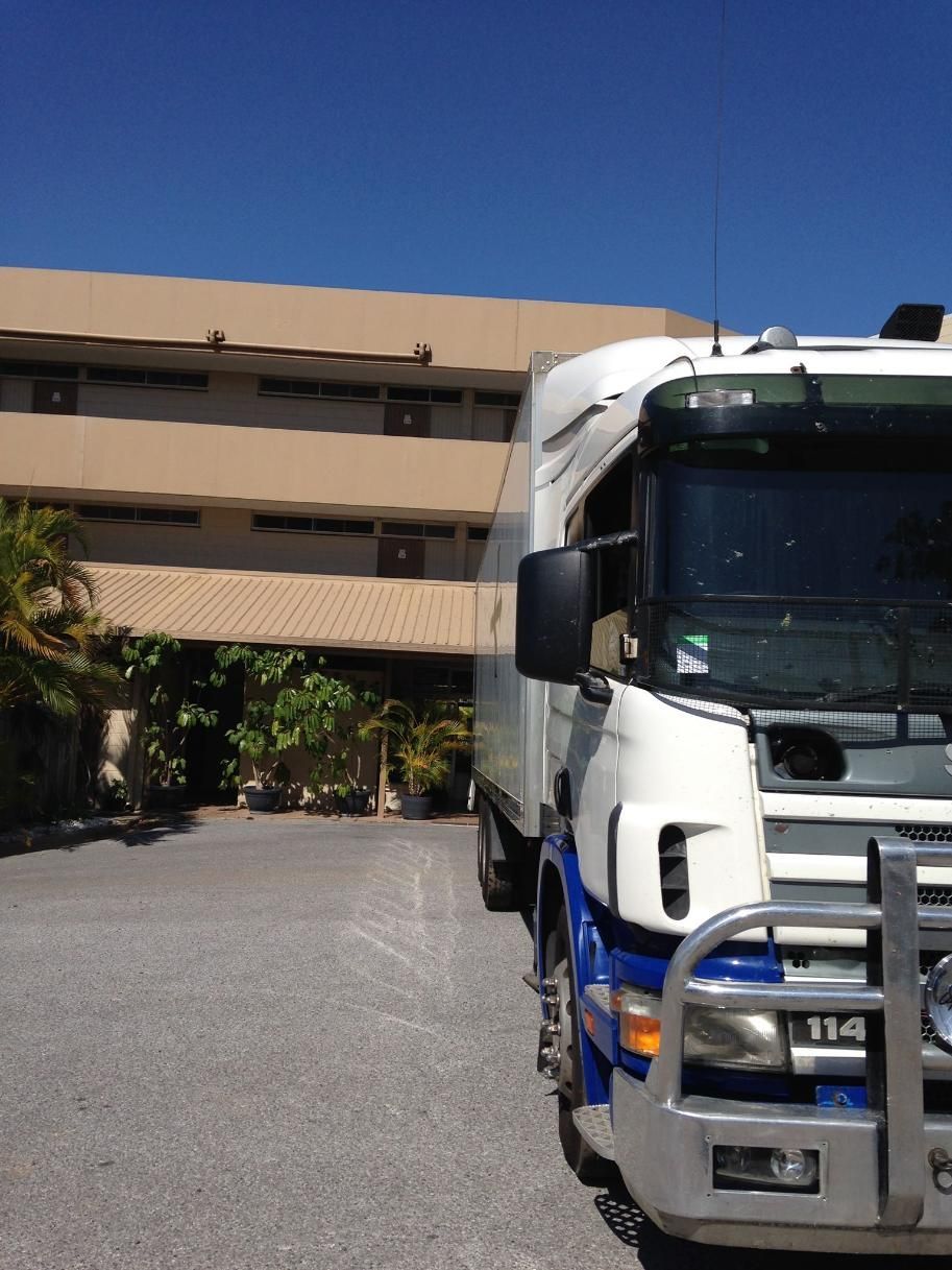 A White Truck With the License Plate Number 114 is Parked in Front of a Building — Wide Bay Removals In Dundowran, QLD