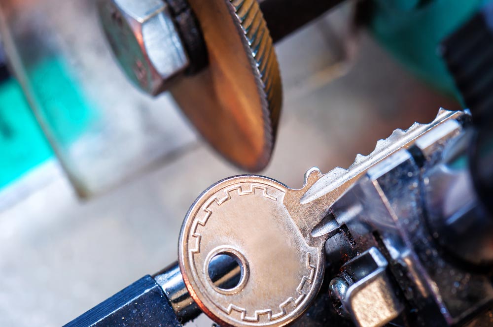 A Key Being Cut — Locksmith In Bendigo, VIC
