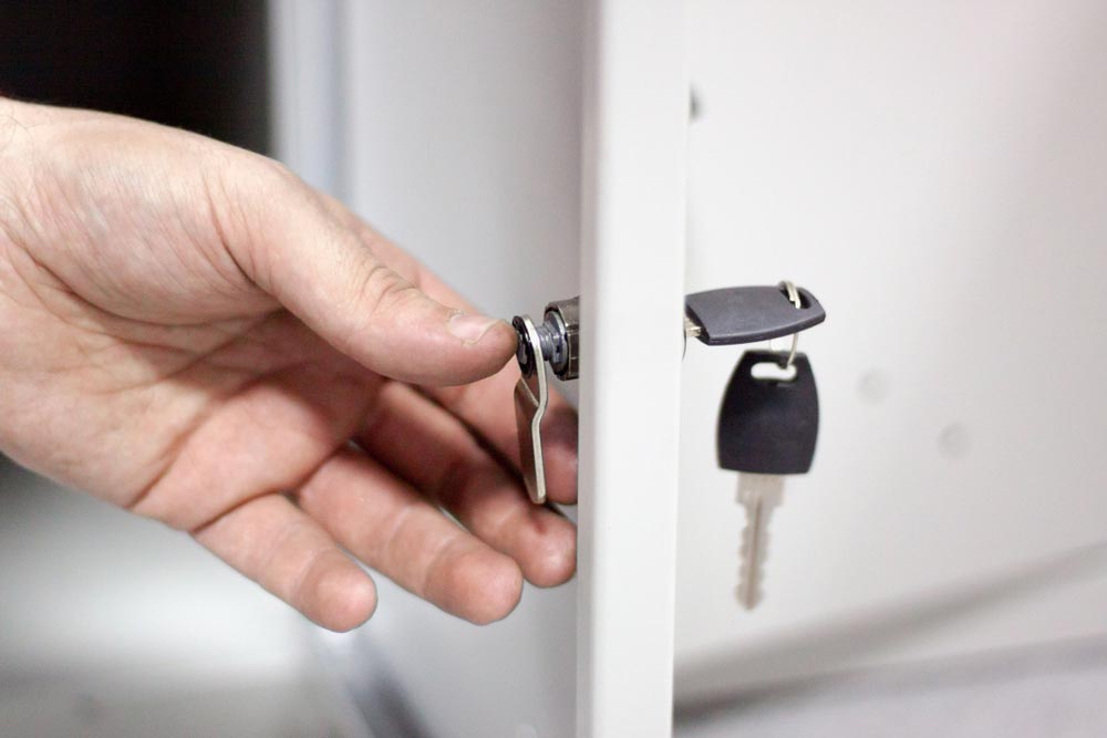 Worker Checking Lock Mechanism — Locksmith In Bendigo, VIC