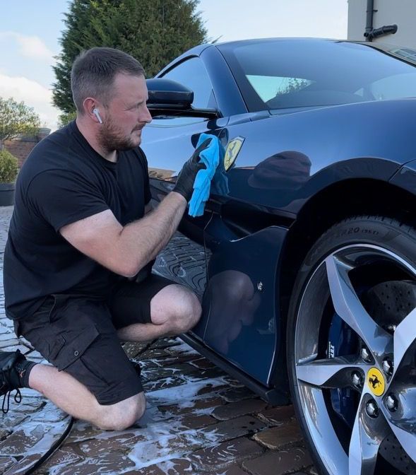 KieMck Valets cleaning a car with a blue cloth
