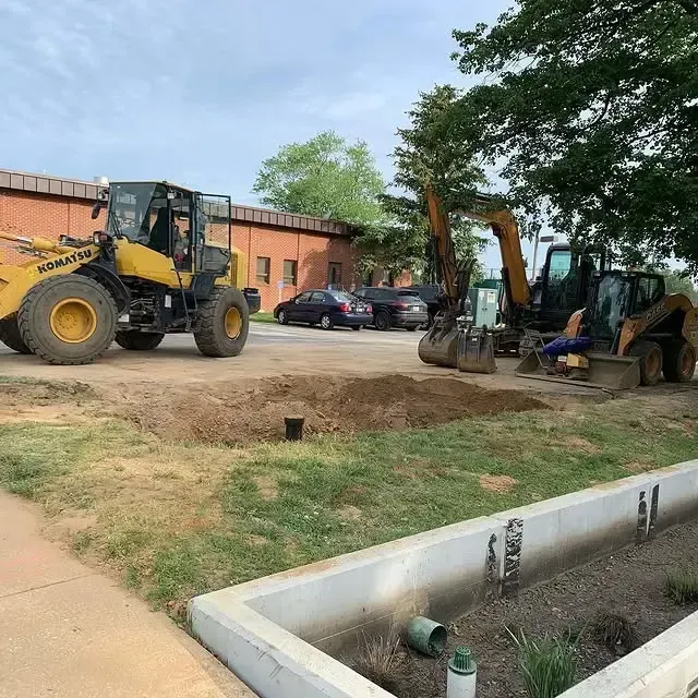 A yellow komatsu tractor is parked in a parking lot