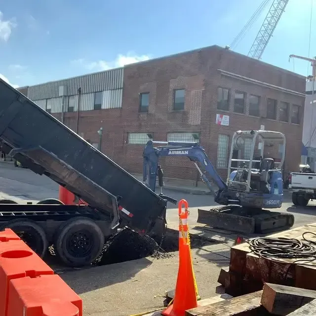 An excavator is being used to dig a hole in the ground