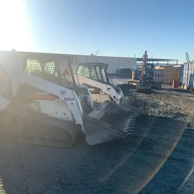 A bobcat skid steer loader is parked in a parking lot.