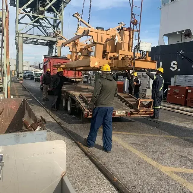 A large u.s. ship is being loaded with cargo