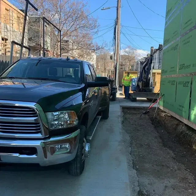 A black truck is parked on the side of the road
