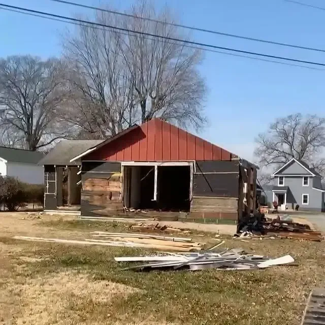 A house with a red roof is being demolished