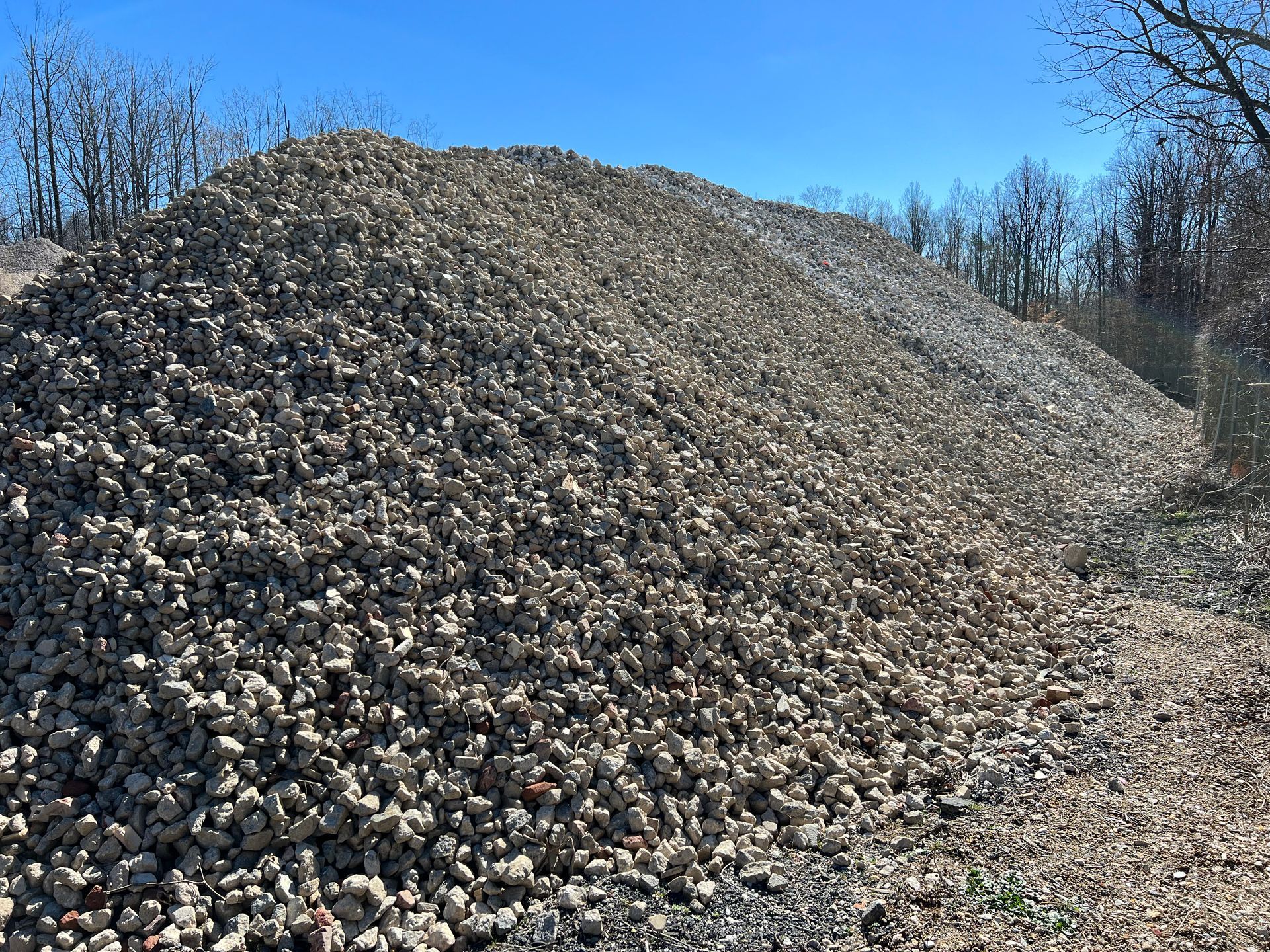 A pile of black gravel is sitting on the ground.