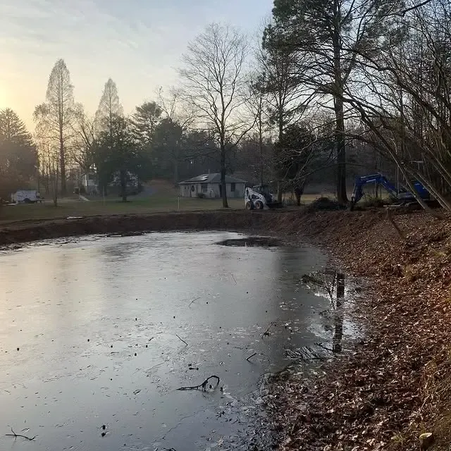 A large body of water surrounded by trees and leaves