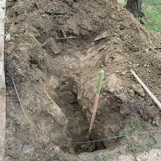 A shovel is sitting in the middle of a pile of dirt.