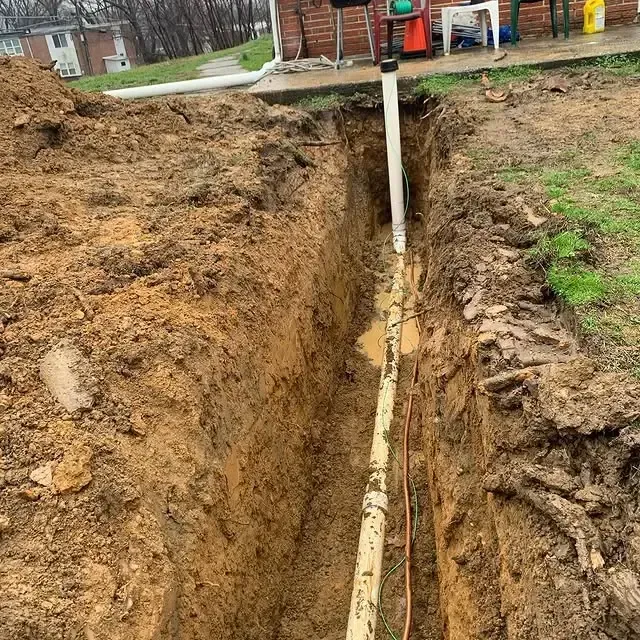 A pipe is being installed in a hole in the ground.