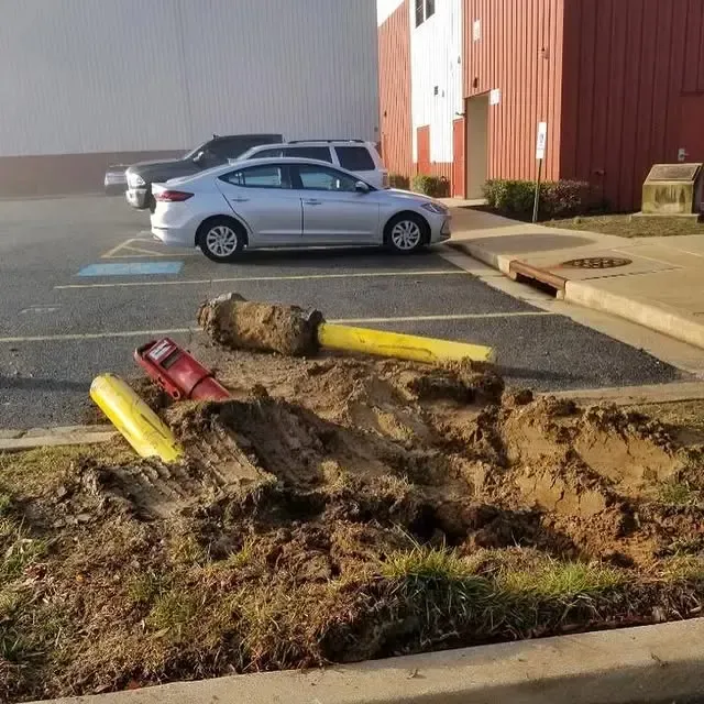 A silver car is parked in a parking lot