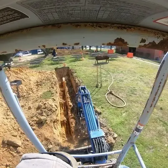 A helicopter is flying over a hole in the ground