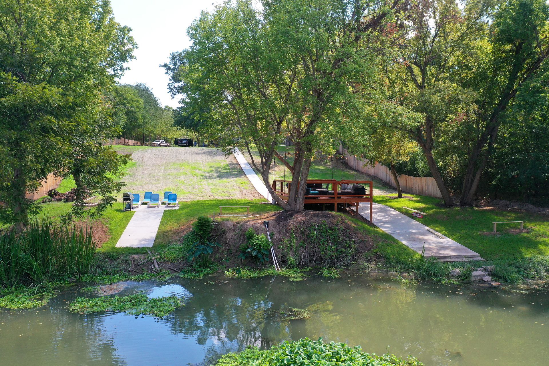 An aerial view of a river surrounded by trees and a viewing deck.