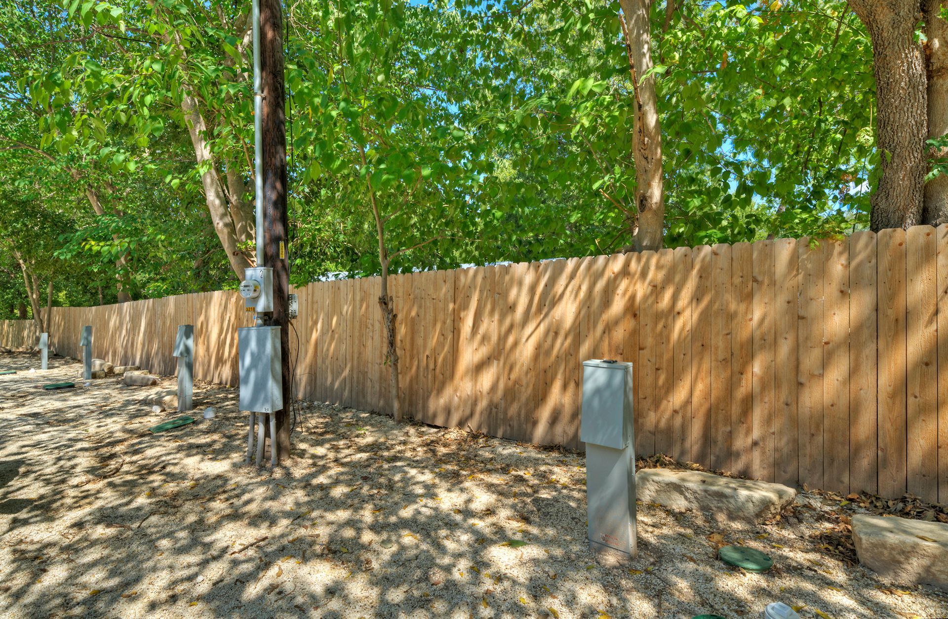 RV hookups in front of a fence.