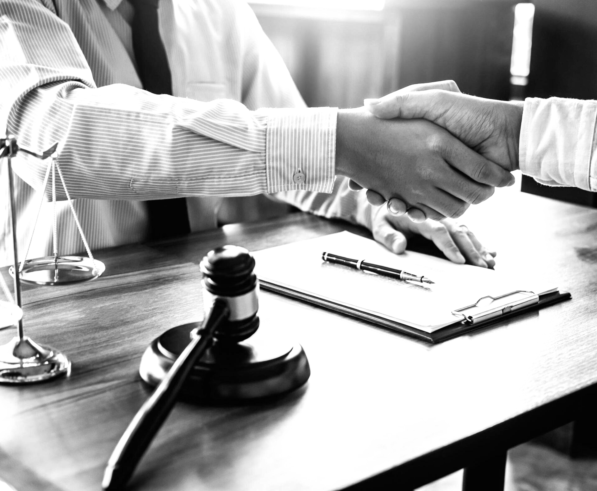 A black and white photo of a judge shaking hands with a client.