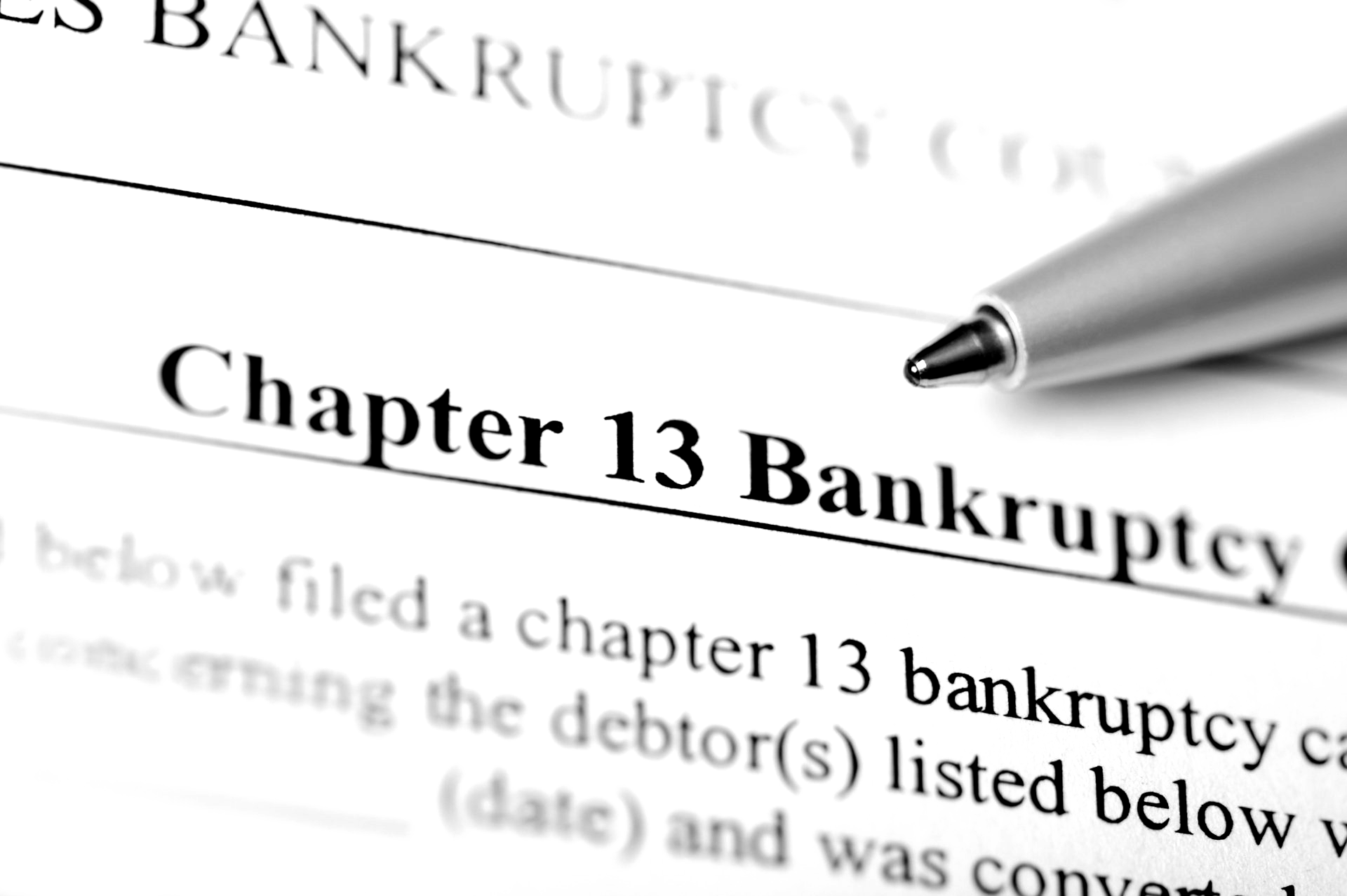 A pen is on a piece of paper that says chapter 13 bankruptcy.