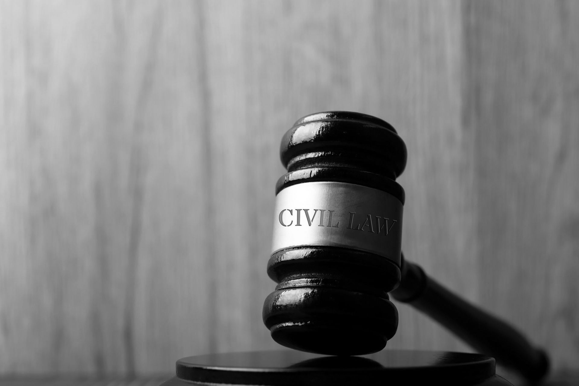 A close up of a judge 's gavel on a wooden table.