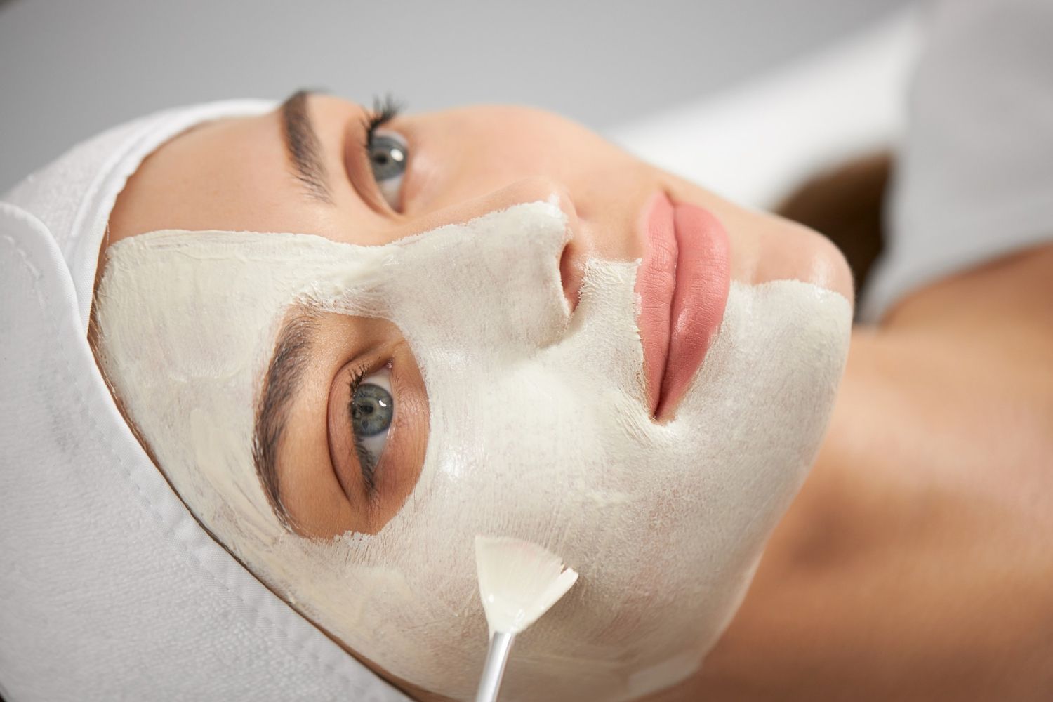 A woman is getting a facial treatment at a spa.