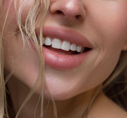 A close up of a woman 's face with a smile on her face.