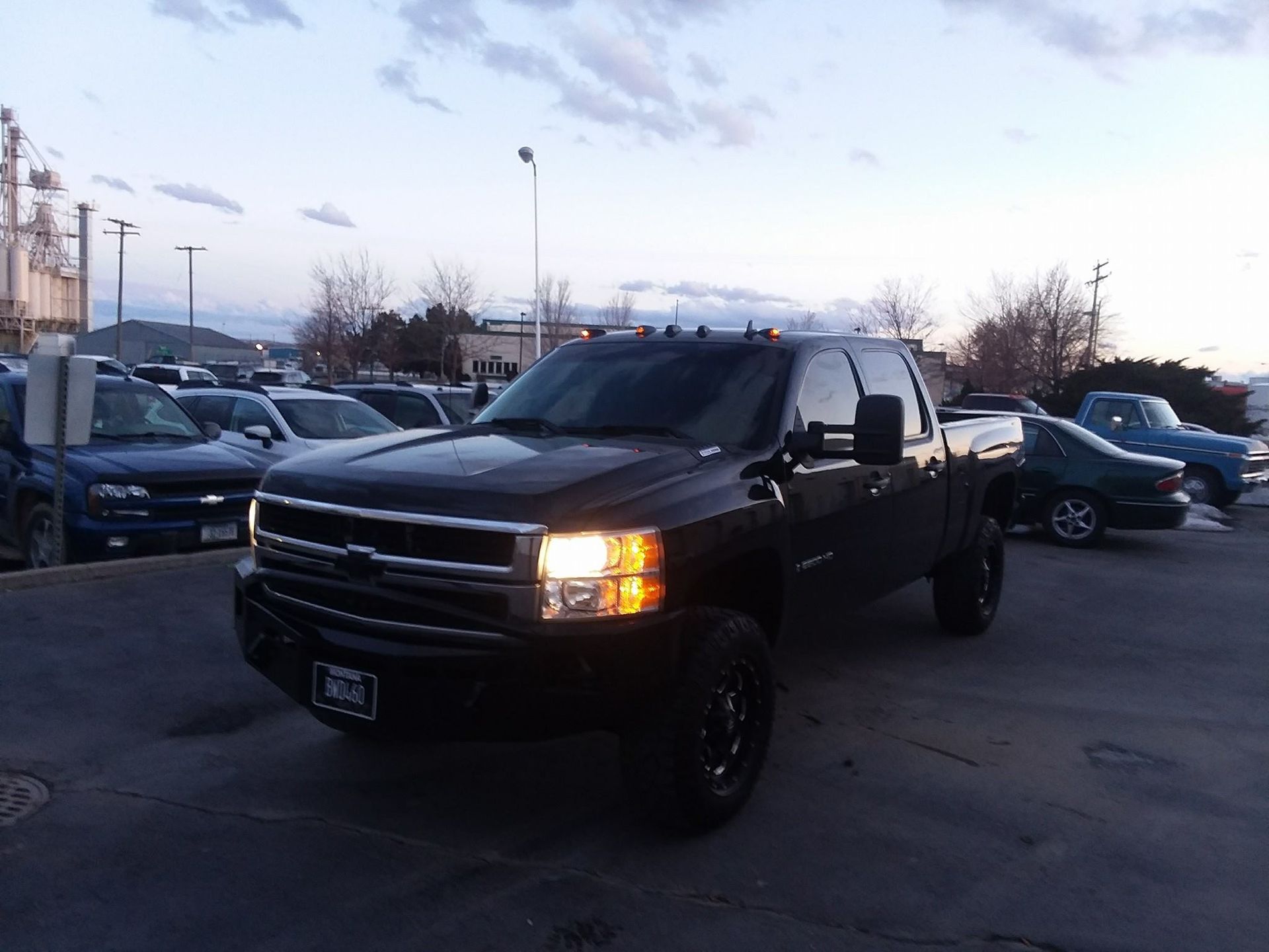 A black truck is parked in a parking lot