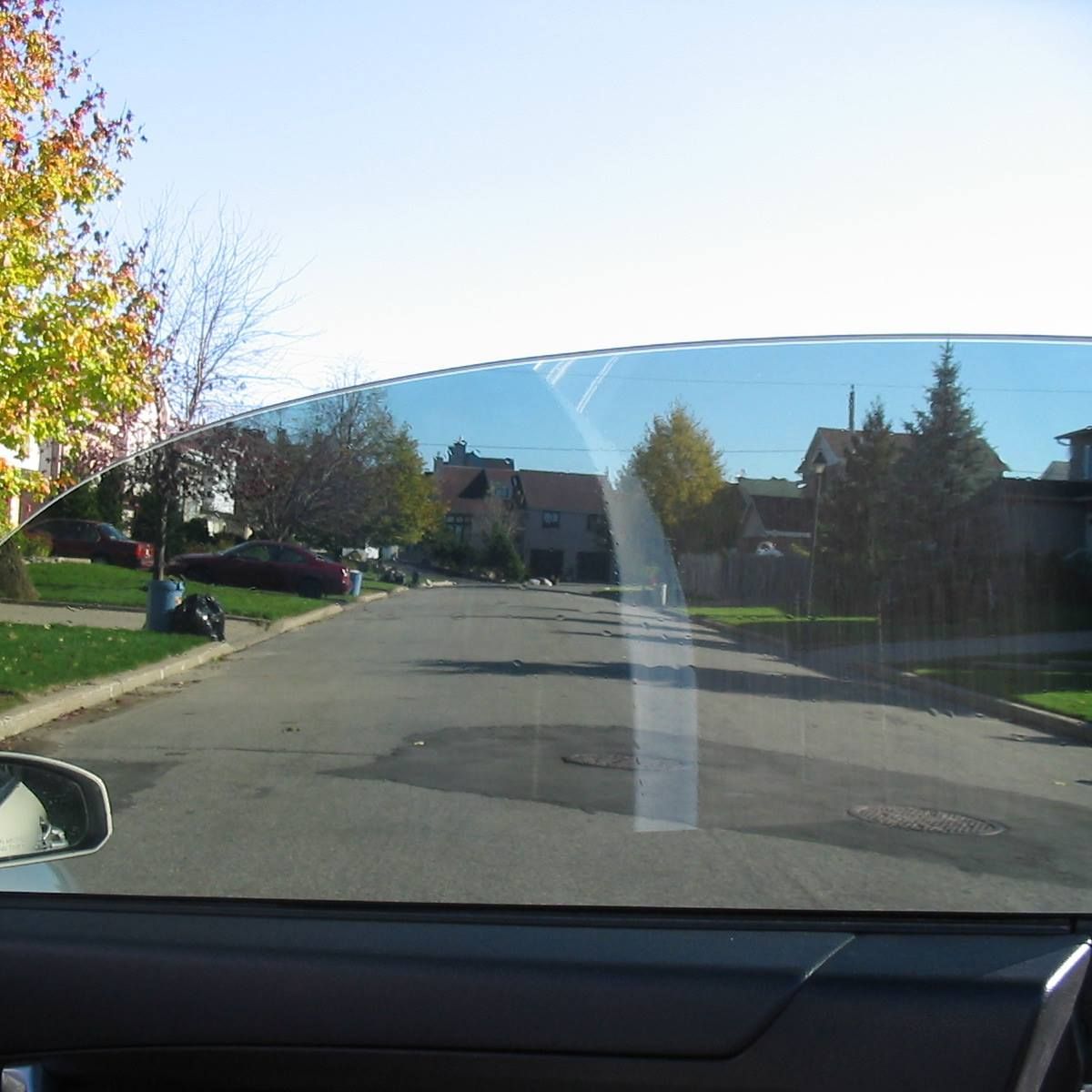 A view of a residential street through a car window